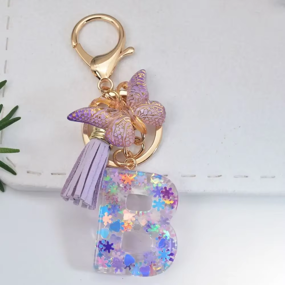 Porte-clés Alphabet A à Z 26 lettres, avec initiales, flocons de neige violets, pompon et sequins